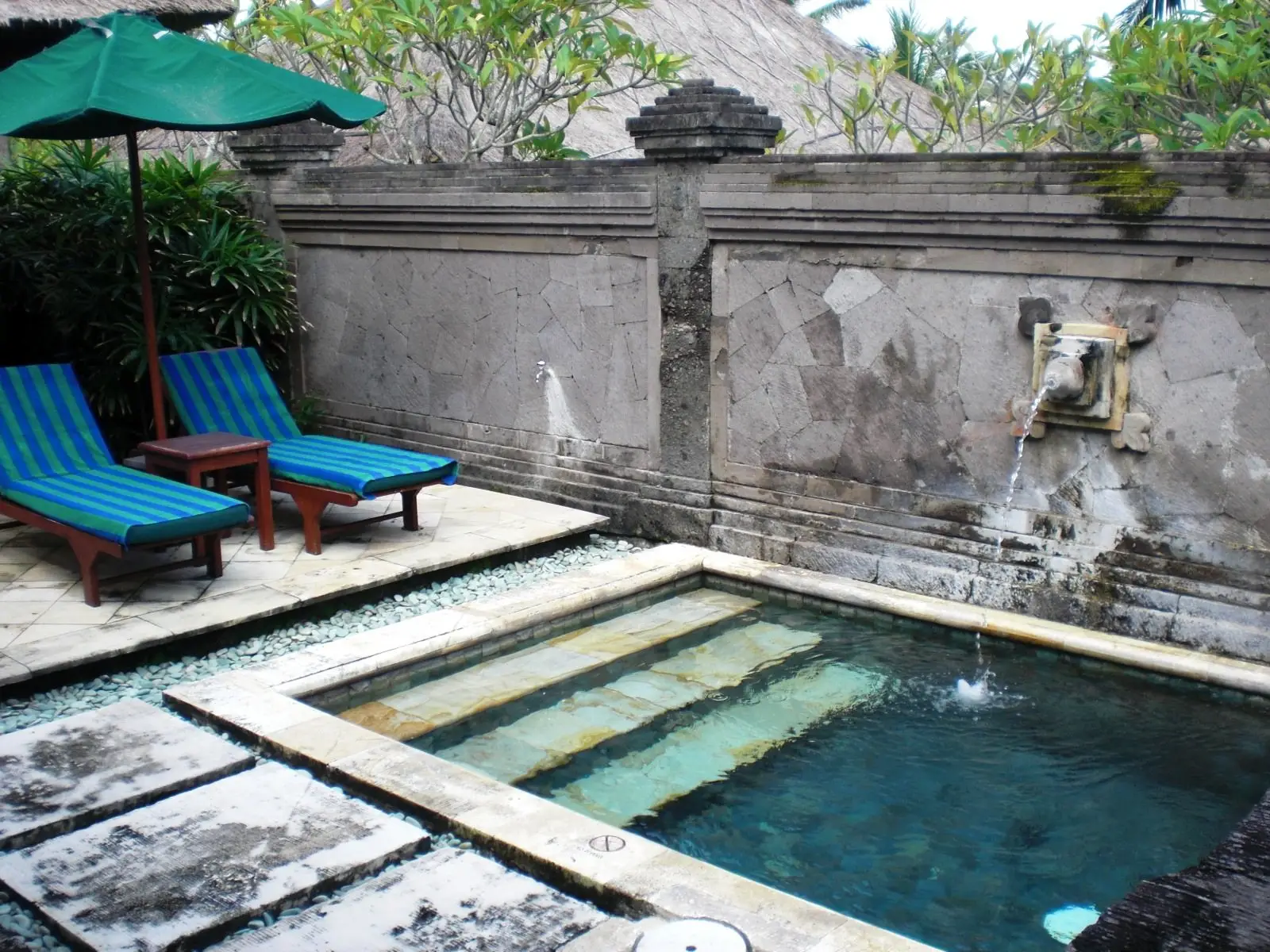 Plunge pool in a stone-walled courtyard