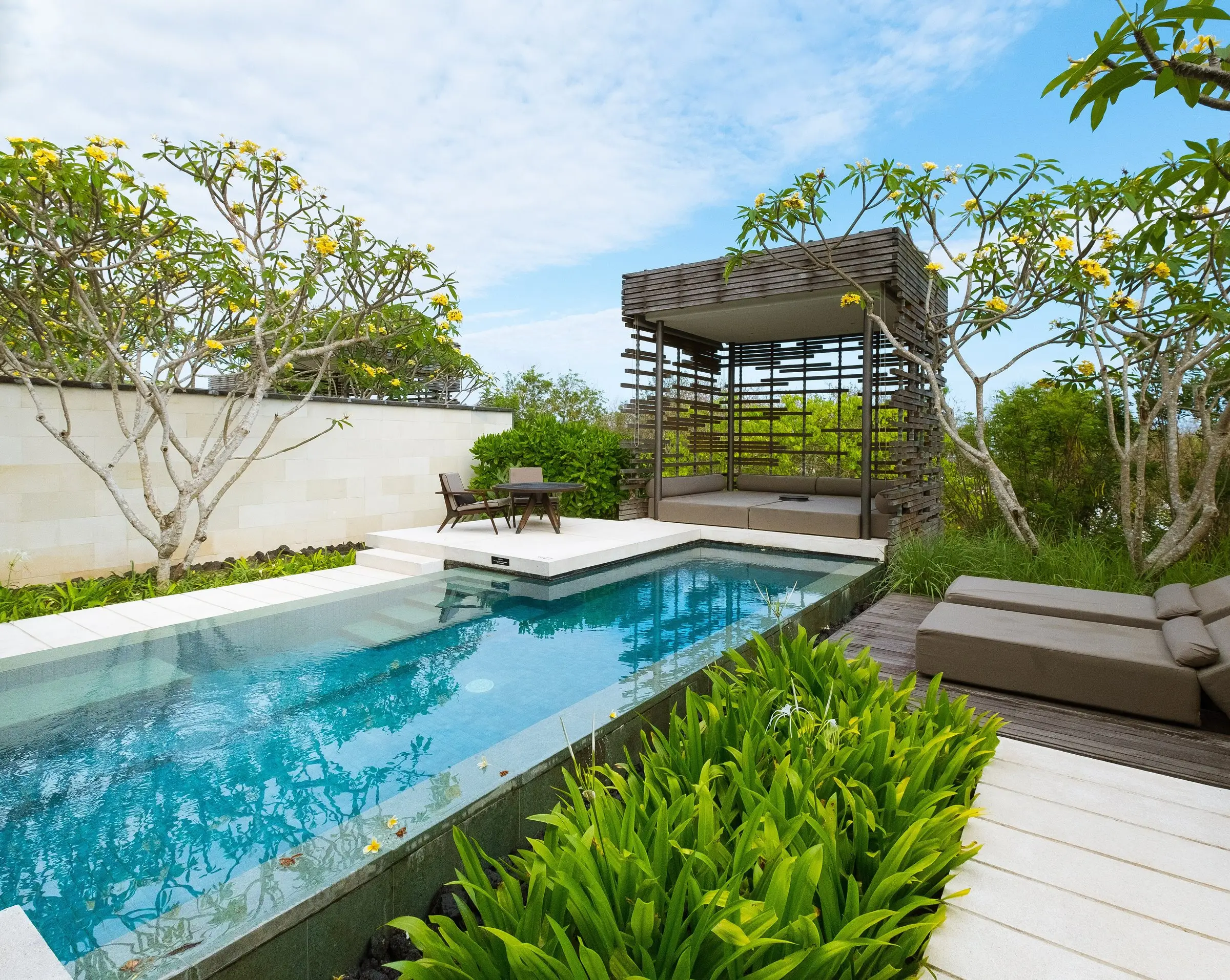 Long pool beside a timber pavilion and planting
