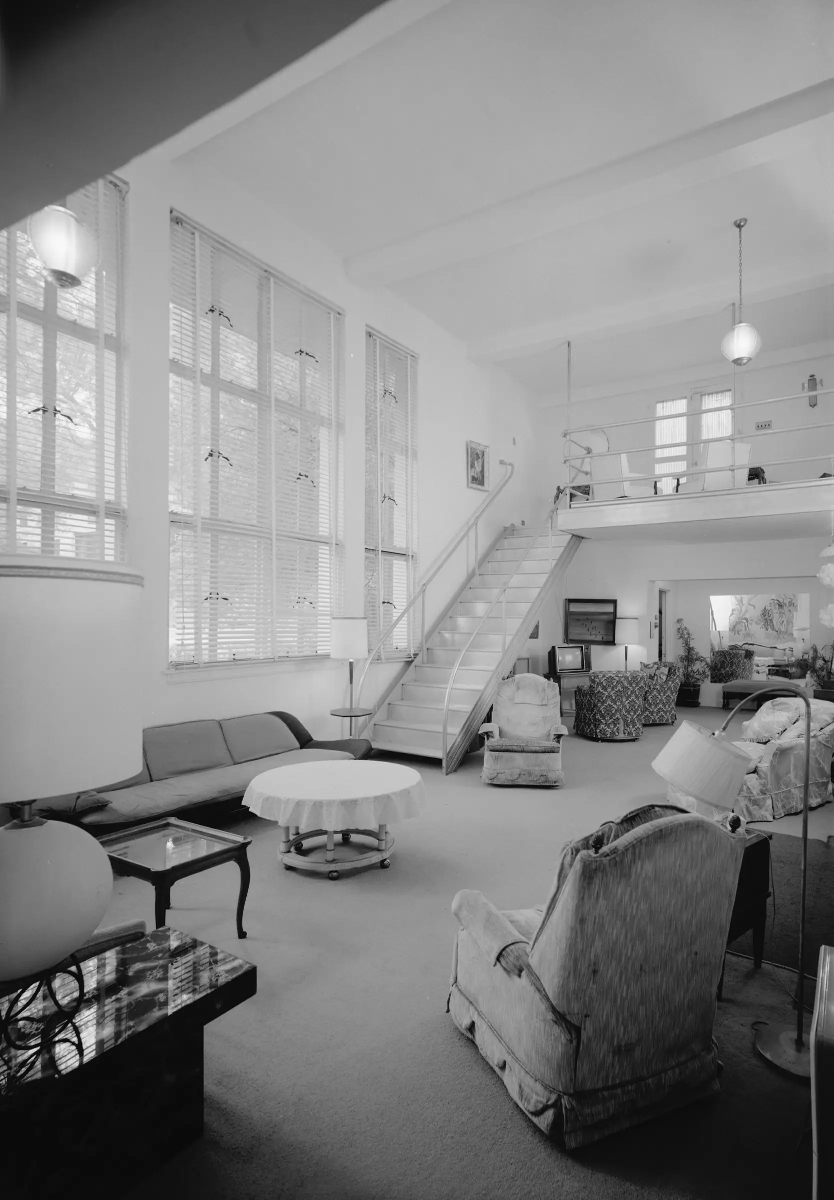 Double-height living room with a gallery above